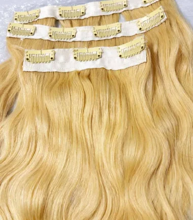 blonde-wavy-clip-in-hair-extensions-3-piece-11-clip-texas Two four-clip wefts and one three-clip blonde hair weft