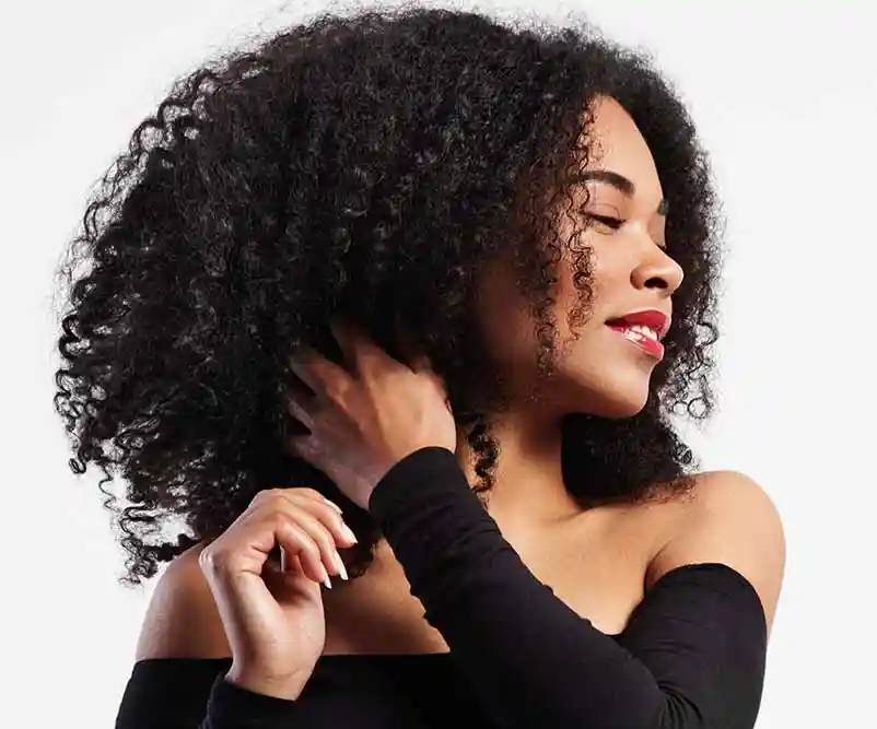 black-woman-touches-her-curly-hair1 Why South Indian Hair?